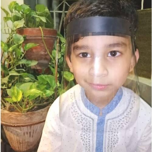 Kids Protective Face Sheild Professional Grade Face Mask - Shield Professional Grade Face Mask worn by a young boy, featuring a clear plastic visor attached to a black headband.
