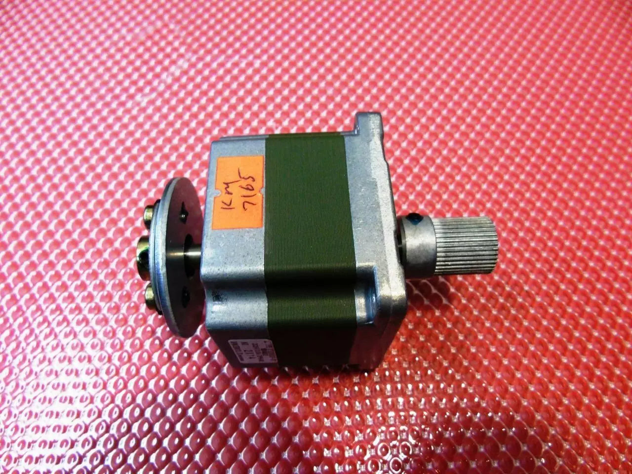 KT60KM06-011 0.6 Degree Step Angle Star Winding 3 Phase Stepper Motor - a silver and dark green square motor with a metal shaft, a knurled knob, and a circular mounting plate.