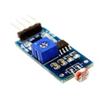 Ky-018 LDR Light Sensor Module - a blue potentiometer, a small photoresistor, and a four-pin header on a blue rectangular circuit board.