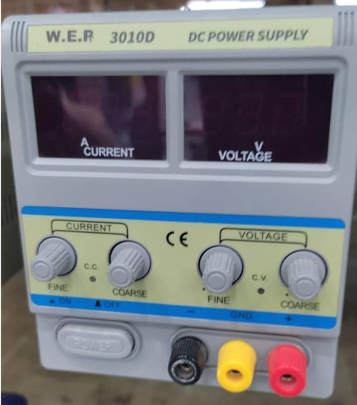 Laboratory Power Supply Wep 3010D 30V 10A - DC power supply, a grey benchtop unit with two digital displays, four adjustment knobs, and three output terminals in black, yellow, and red.