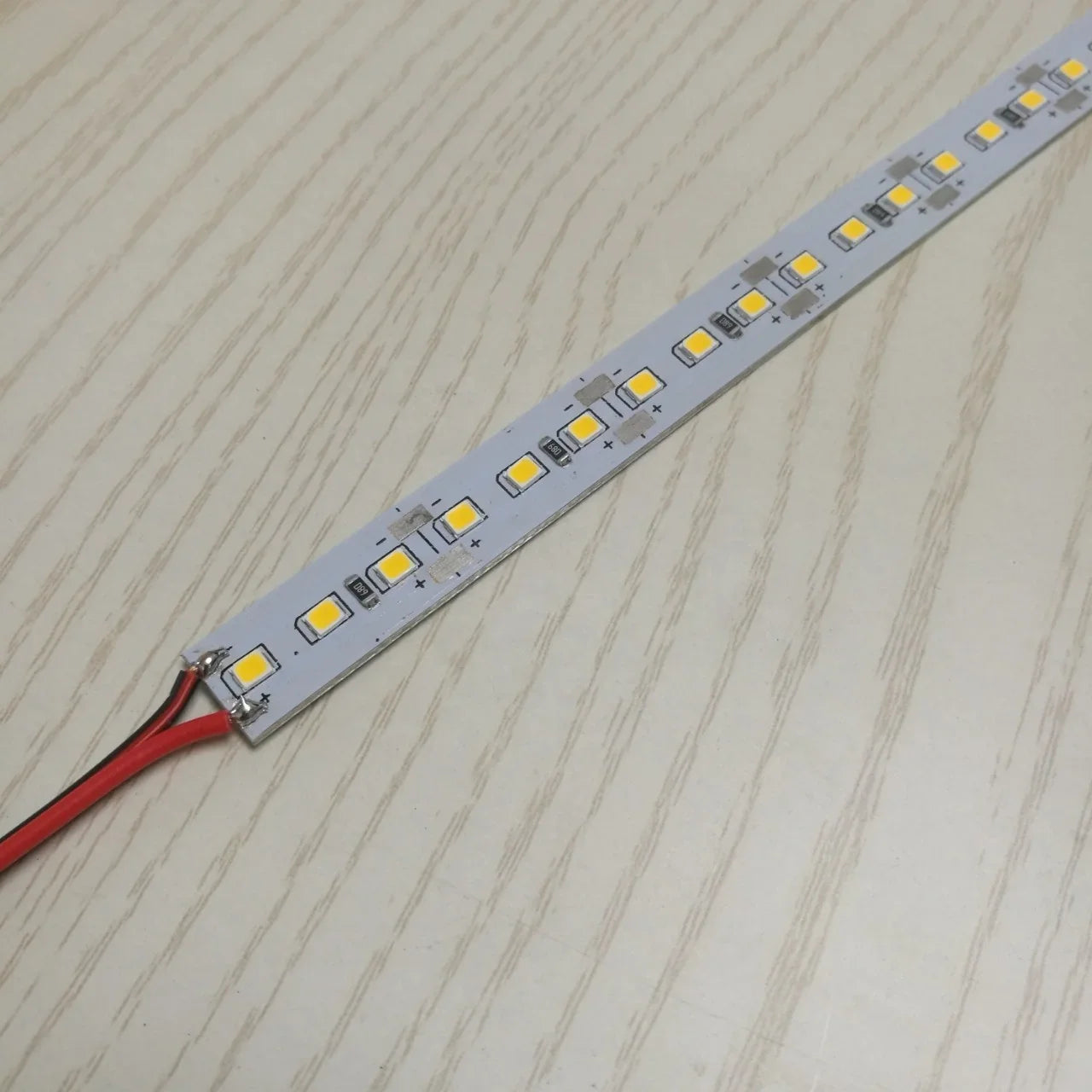 Lahore Only White LED Strip SMD White Color Ultra Thin LED Hard Aluminum Profile - a rigid white LED strip with soldered red and black wires.