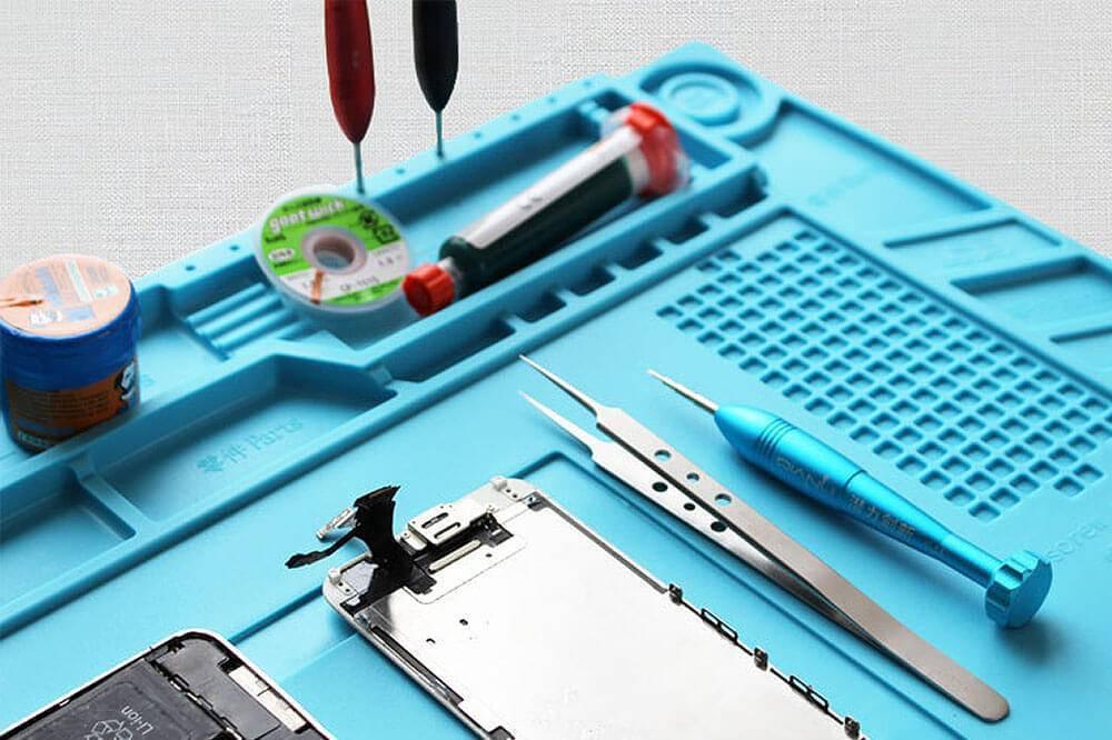 Large Heat Insulation Silicone Soldering & Repairing Mat - compartments holding a solder spool, desoldering pump, tweezers, and screwdriver.