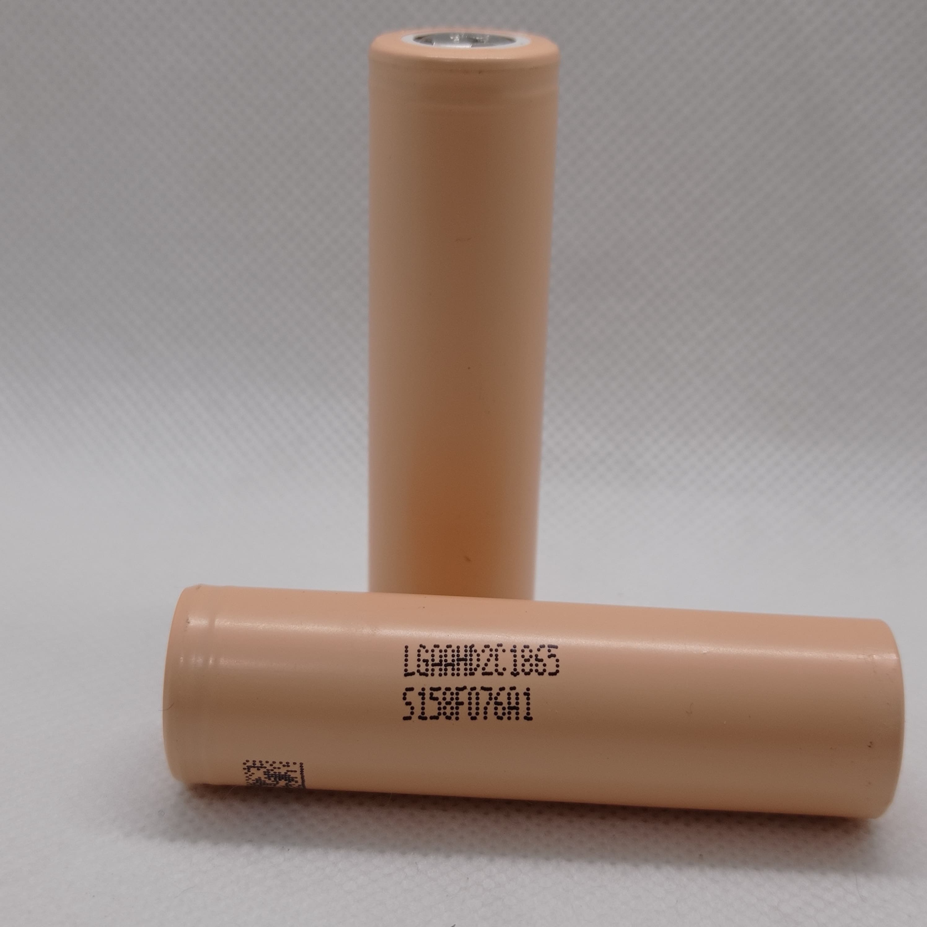 LGAAHD2C1865 3.7V 2100mAh High-drain 18650 Li-ion Battery - two cylindrical peach-colored cells with printed model numbers and a QR code on a white background.