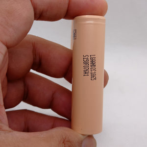 LGAAHD2C1865 3.7V 2100mAh High-drain 18650 Li-ion Battery - a peach-colored cylindrical cell held in a hand, showing the printed model number and code on its side.
