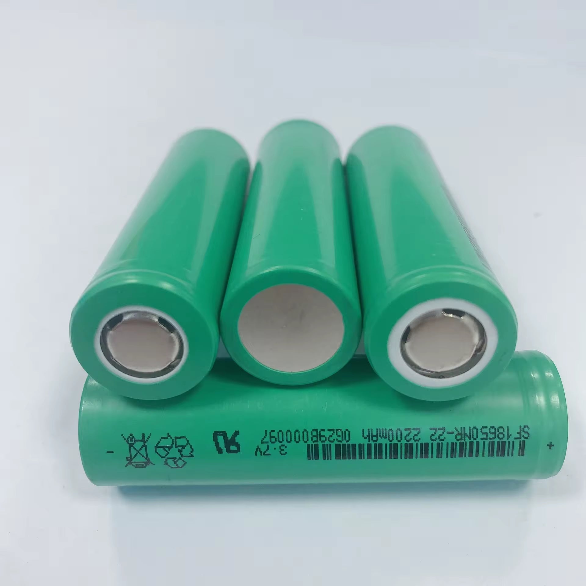 Li-ion 18650 2200mAh Rechargeable Battery Cell (SF 18650NR-22) - three green cylindrical batteries arranged with two upright and one laying horizontally.