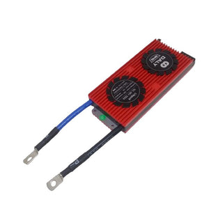 LiFePO4 16S 48V 100A DC Daly BMS - a red rectangular heat-sink module with two circular labels and two black cables with metal ring terminals attached.