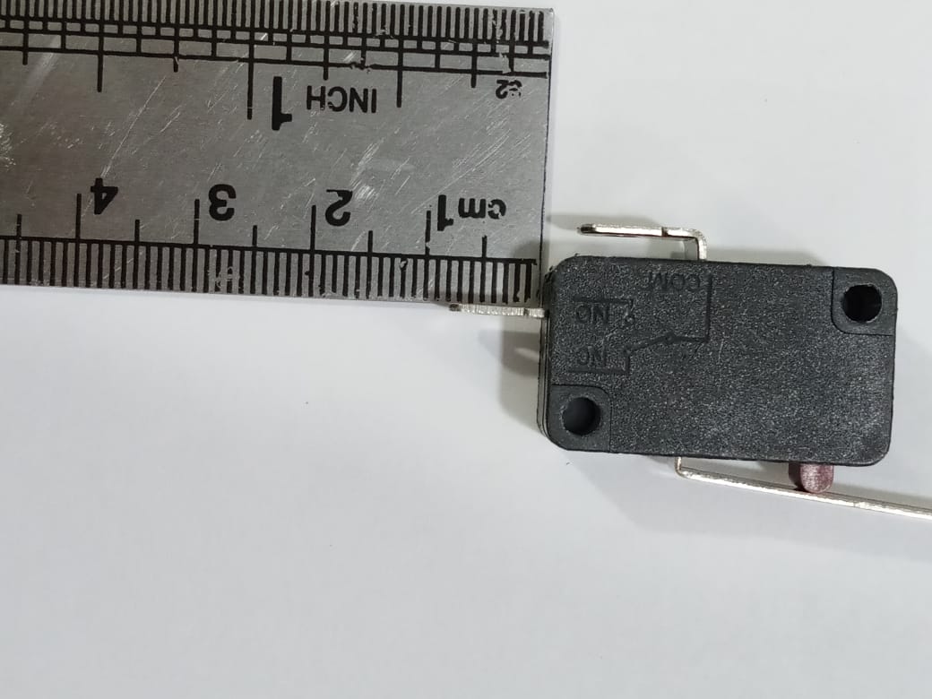 Limit switch - a black rectangular component with a metal lever, shown next to a metal ruler to indicate its size.
