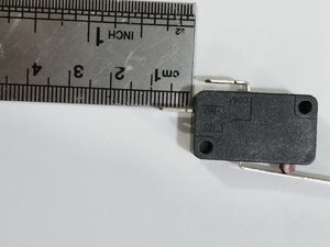 Limit switch - a black rectangular component with a metal lever, shown next to a metal ruler to indicate its size.