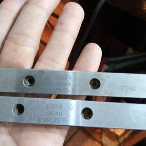 Linear Bearing Slide Rail CNC Router - a close-up showing two silver metal rails with IKO LWL15 B markings and mounting holes held in a hand.