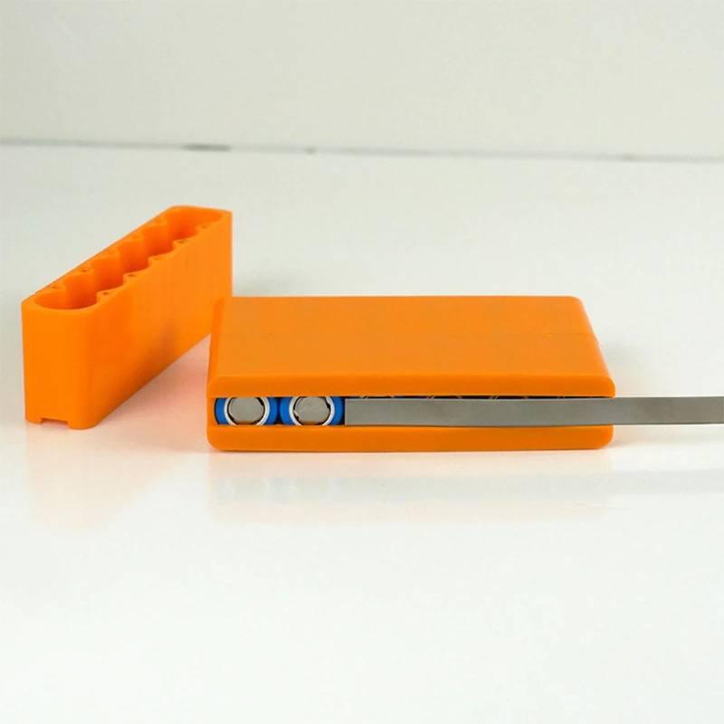Lithium Battery Fixture Single Row Double-sided 18650 Battery Spot Welding Fixer Battery Pack Fast Welding Fixed Bracket G8tb - two orange plastic brackets, one holding cylindrical batteries with a metal strip.