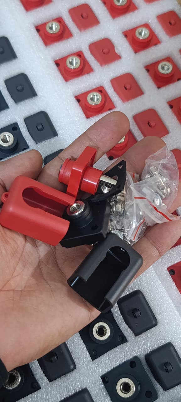 Lithium Battery Power Terminal All-Copper Quick Connector Pair 120A - shown as a hand holding two connectors with protective covers and a bag of hardware.