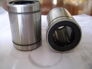 LM10UU 10mm 10x19x29mm Ball Bearing Bush Bushing For 3d Printer Parts - two silver cylindrical metal bushings with black interior ball bearing tracks positioned on a white surface.