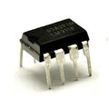 LM311 - a black 8-pin DIP integrated circuit chip with metal legs, shown from a slightly elevated angle against a white background.