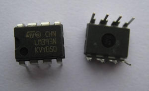 LM393 Dual Differential Comparator IC - shown as two black, eight-pin integrated circuit chips with white text markings on a plain white background.