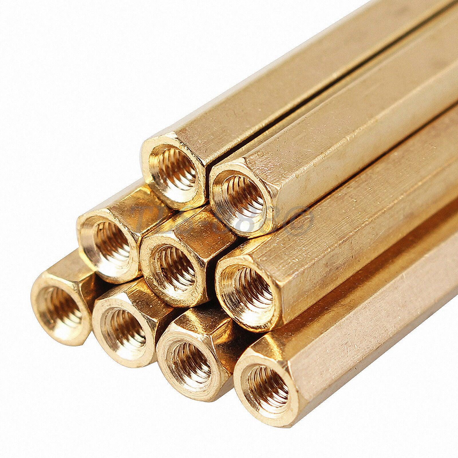 M3X55MM Female To Female Thread Brass Hex Standoff PCB Pillar Spacer - a close-up stack of several gold-colored hexagonal metal spacers.