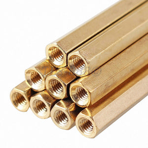 M3X55MM Female To Female Thread Brass Hex Standoff PCB Pillar Spacer - a close-up stack of several gold-colored hexagonal metal spacers.