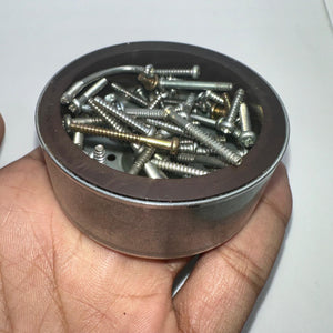 Magnet for storing screws and metal - a round, silver-coloured magnetic bowl held in a hand and filled with various metal screws.