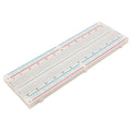 MB102 Breadboard 830 Points Solderless Prototyping Breadboard High Quality - with 830 tie points, shown at an angle with its numbered contact rows and red and blue power rails along both edges.