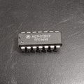 MC14013BCP Dual D-Type Flip-Flop IC - a black 14-pin integrated circuit chip with white text markings on its surface, shown in a top-down close-up view.
