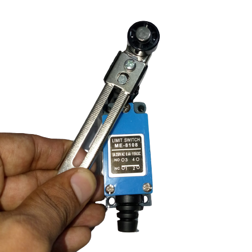 Me-8108 Mini Limit Switch - held in a hand, featuring a blue rectangular body with a metal roller lever arm and a label showing terminal numbers 1, 2, 3, 4.