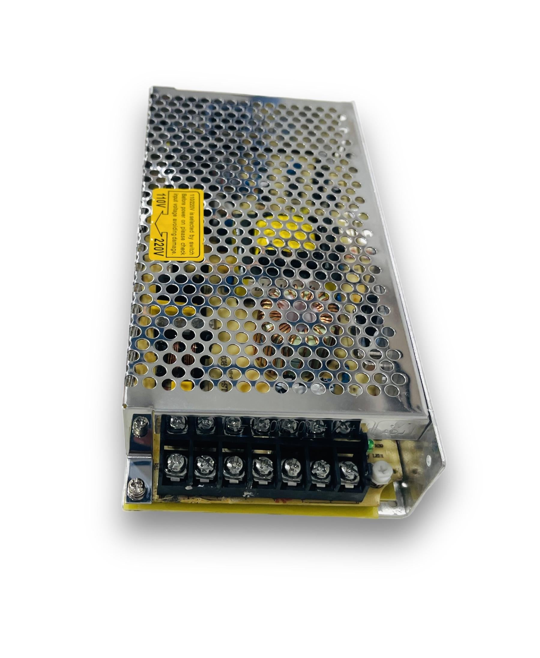 Meanwell 120W 5A 24V 5A Meanwell Power Supply - in a rectangular silver metal case with a perforated cover, a voltage selection warning label, and a screw terminal block.