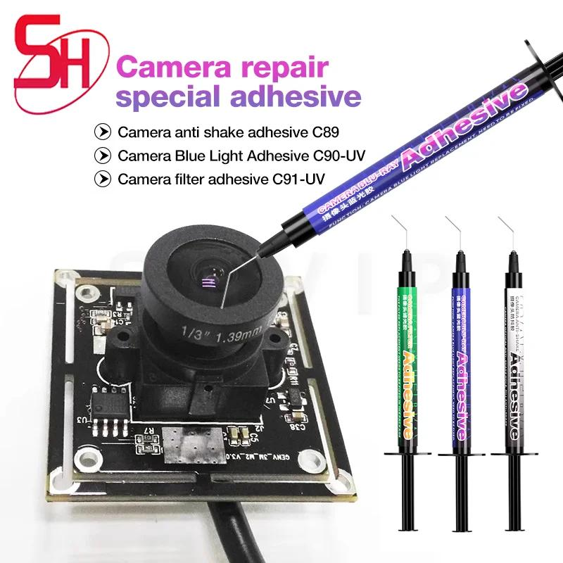 MECHANIC C91-UV CAMERA FILTER ADHESIVE - square camera module with a central lens and three needle-tipped adhesive syringes in green, blue, and black packaging labeled "Adhesive".