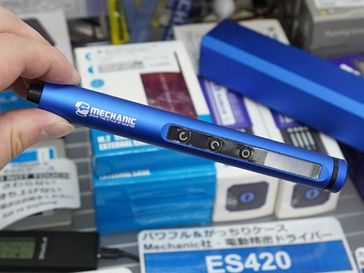 Mechanic Electric Screwdriver ES420 Price - held in a hand, showing a blue cylindrical body, three circular control buttons, and a small screen.