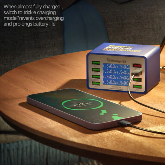Mechanic Icharge 8p / 8s Qc 3.0 Multi-port Smart Fast Charger With Digital Display - a blue rectangular device with a digital display showing port readings, connected to a smartphone on a wooden table.