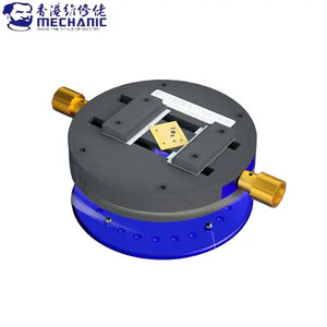 MECHANIC MK1 UNIVERSAL CLAMPING FIXTURE - Repair Fixture - circular grey and blue metal fixture with two gold-colored side knobs and a central clamping mechanism holding a small square gold component.