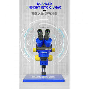 Mechanic Mos 300 Stereo Trinocular Microscope 6-45x with B11 Big Base - a blue and black body with yellow focus knobs, mounted on a large blue base against a graphic backdrop.