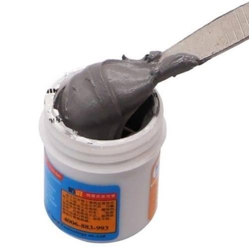 Mechanic Soldering Flux Paste 35gram Soldering Tin Mcn 300 Solder Welding Cream SN63 PB37 XG50 - shown in a white plastic jar with a metal spatula scooping out a portion of the grey solder paste.