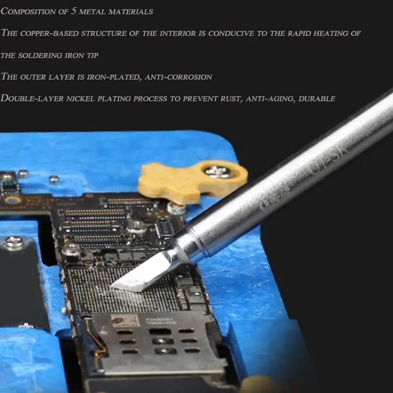MECHANIC TIP OT SK - Soldering Iron Tip - silver-coloured metal soldering iron tip with a chisel point and engraved text, resting against a circuit board held in a blue silicone repair mat.