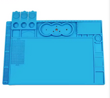 MECHANIC V56 HEAT INSULATION MAT - rectangular bright blue silicone work mat featuring a grid section, various recessed tool organizers, and circular screw compartments on a white background.