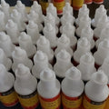 Metal Soldering Flux 25ML Bottle - shown as a bulk collection of small white plastic squeeze bottles with yellow labels and pointed caps.