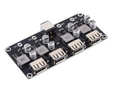 MH-KC24 4-channel DC-DC Buck Converter With QC3.0 Fast Charging - 6-32V To 3V/5V/9V/12V/24V - a black circuit board featuring a DC power jack, four USB-A output ports, and several capacitors and inductors.