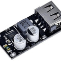 MH-KC24 QC3.0 QC2.0 USB Quick Charging Board Module DC To DC Buck Converter - a black circuit board featuring a silver USB-A port, a grey inductor, and two cylindrical capacitors.