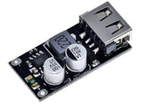 MH-KC24 QC3.0 QC2.0 USB Quick Charging Board Module DC To DC Buck Converter - a black circuit board featuring a silver USB-A port, a grey inductor, and two cylindrical capacitors.