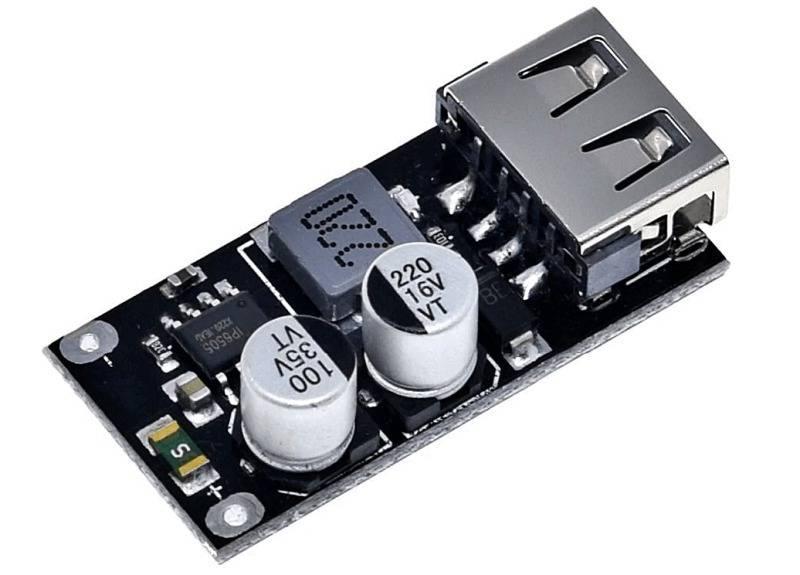 MH-KC24 QC3.0 QC2.0 USB Quick Charging Board Module DC To DC Buck Converter - a black circuit board featuring a silver USB-A port, a grey inductor, and two cylindrical capacitors.