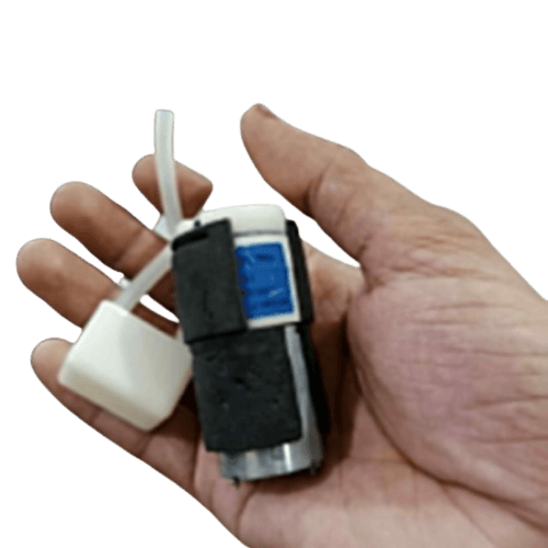 Micro Air Pump - held in a hand, featuring a silver cylindrical motor with a black foam casing, a blue label, and a white plastic nozzle with a tube.