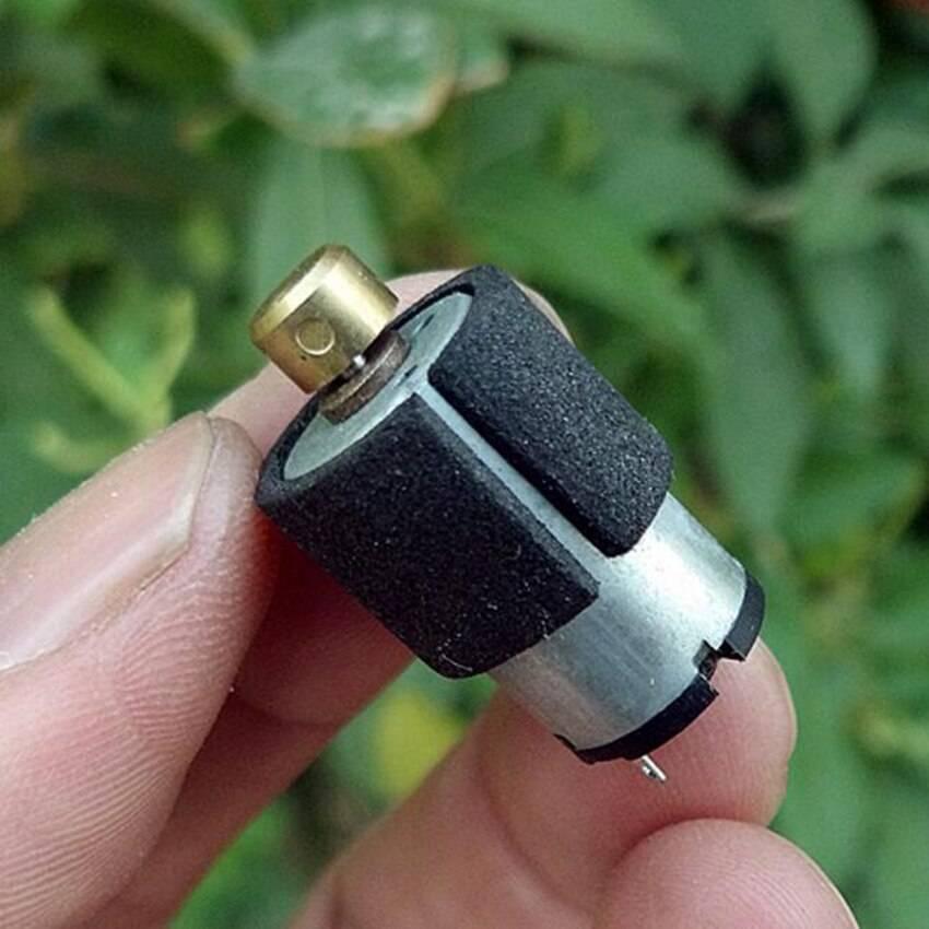 Micro Vibration Motor Vibrator Dc3v-6V 1220 - shown held in fingers, featuring a silver cylindrical body with a black foam sleeve and a brass cap.