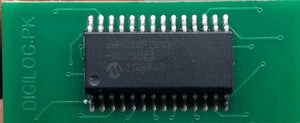 Microchip DSPIC30F2010 Microcontroller - 14-bit DSC with DSP - a black integrated circuit chip with 28 pins soldered onto a green printed circuit board.
