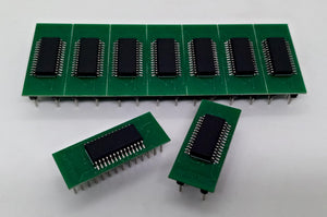 Microchip DSPIC30F2010 Microcontroller - 14-bit DSC with DSP - shown as seven chips mounted on green circuit boards in a row, with two additional boards placed in the foreground.