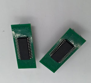 Microchip DSPIC30F2010 Microcontroller - 14-bit DSC with DSP - two green rectangular circuit boards with black integrated circuits mounted on the top surface.