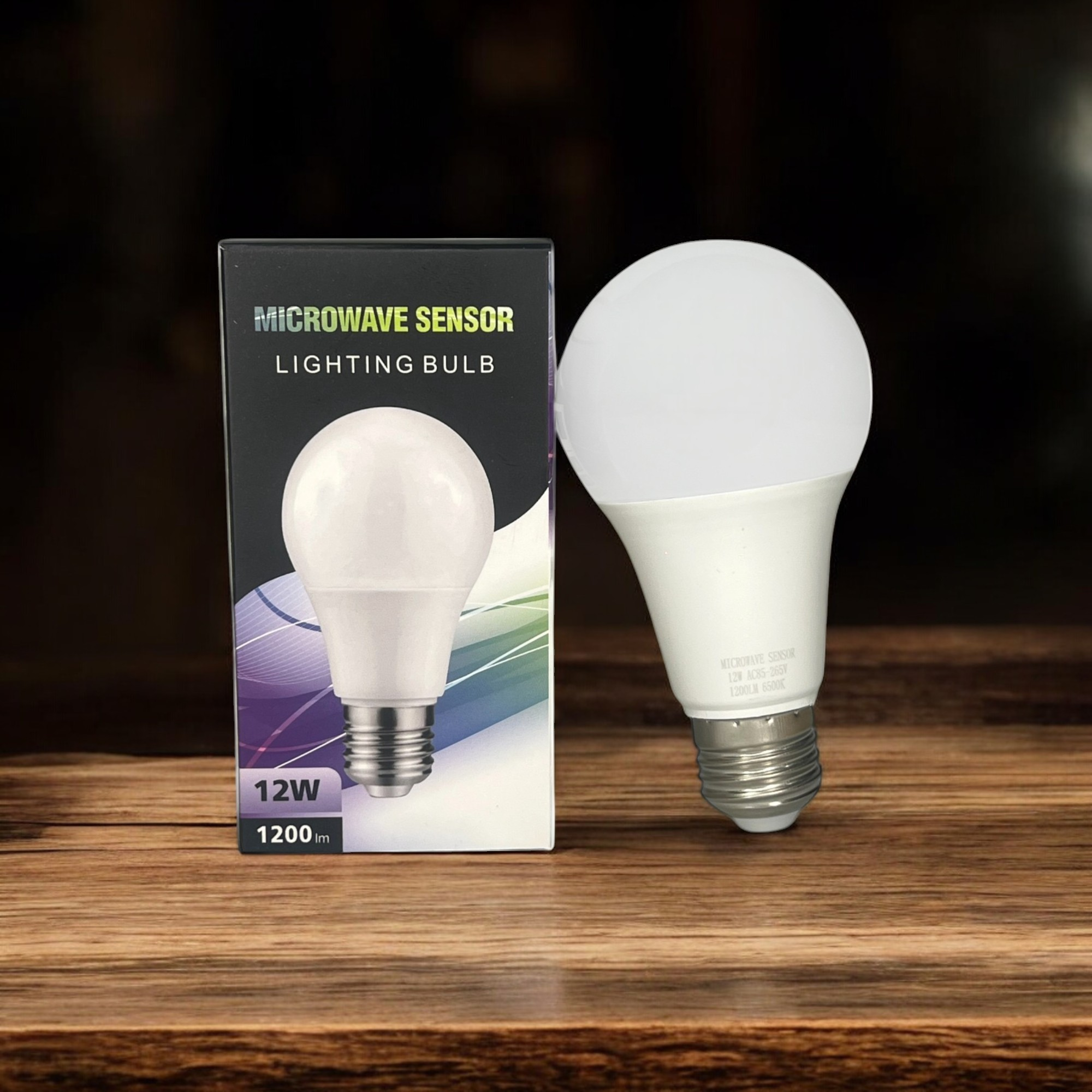 Microwave Sensor LED Lighting Bulb 12W – 1200LM (1 Pc) - one white LED bulb standing next to its black and white product packaging box.