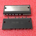 MIG20J501L IGBT Module Toshiba - shown as two identical black rectangular electronic components with metal heat sinks and multiple pins on a red surface.