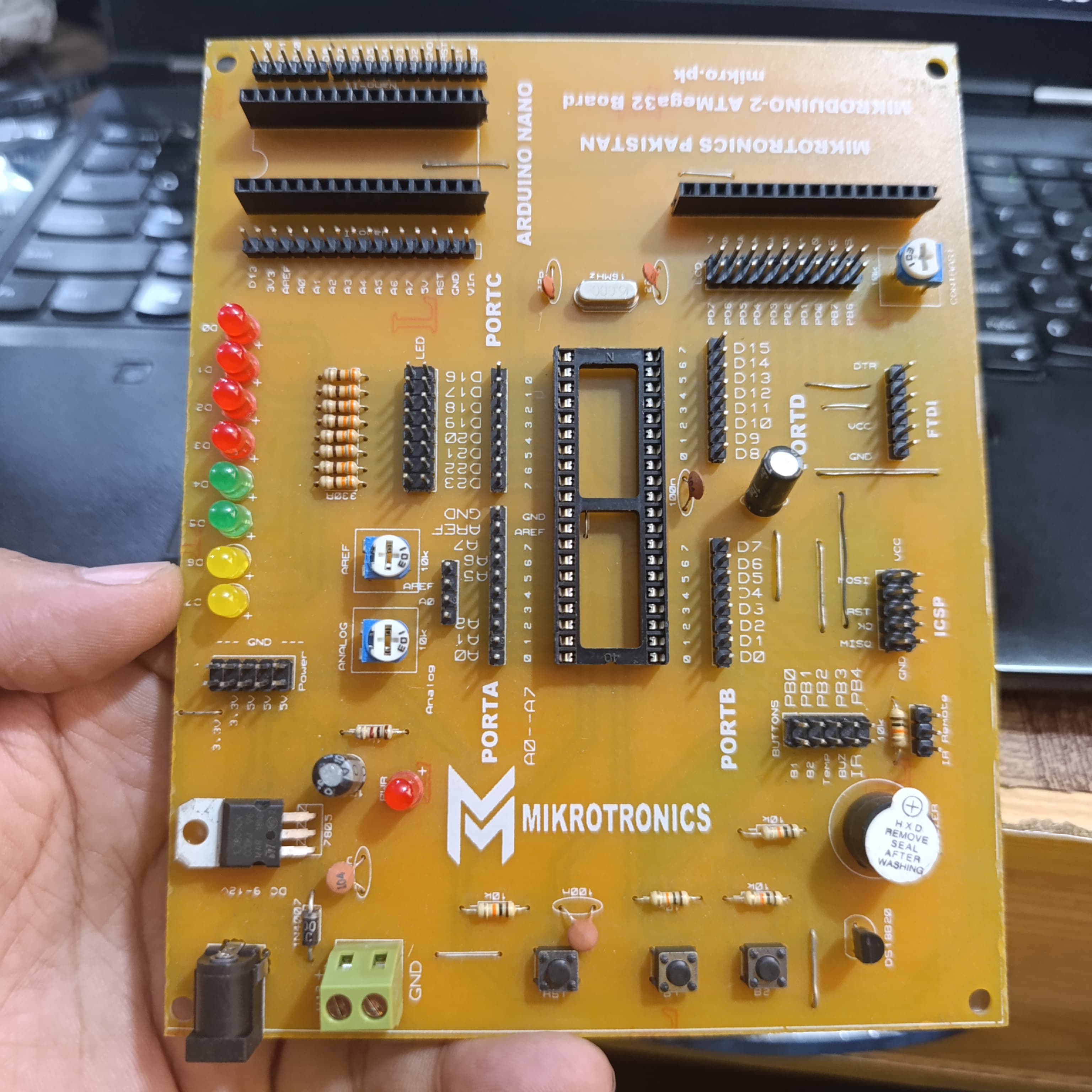MikroDuino-II AVR ATMEGA32 Arduino Compatible Board Without LCD ,IC And Arduion - a yellow, rectangular PCB featuring an empty 40-pin IC socket, multiple LED indicators, pin headers, and ports.