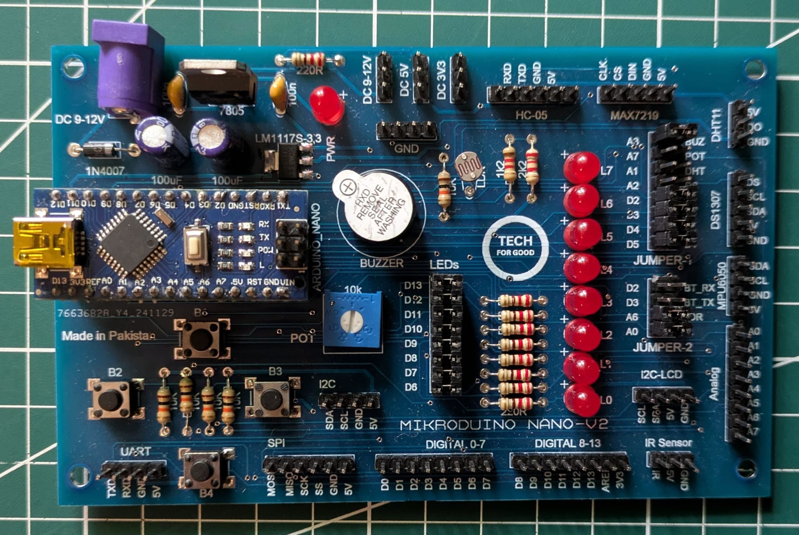 Mikroduino Nano — Arduino Nano Trainer Development Board And Learning Shield Board Made - a blue rectangular circuit board featuring an Arduino Nano, a buzzer, ten red LEDs, a potentiometer, and headers.