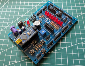 Mikroduino Nano — Arduino Nano Trainer Development Board And Learning Shield Board Made - with a blue PCB, featuring a mounted Arduino Nano, eight red LEDs, four push buttons, a buzzer, and a potentiometer.