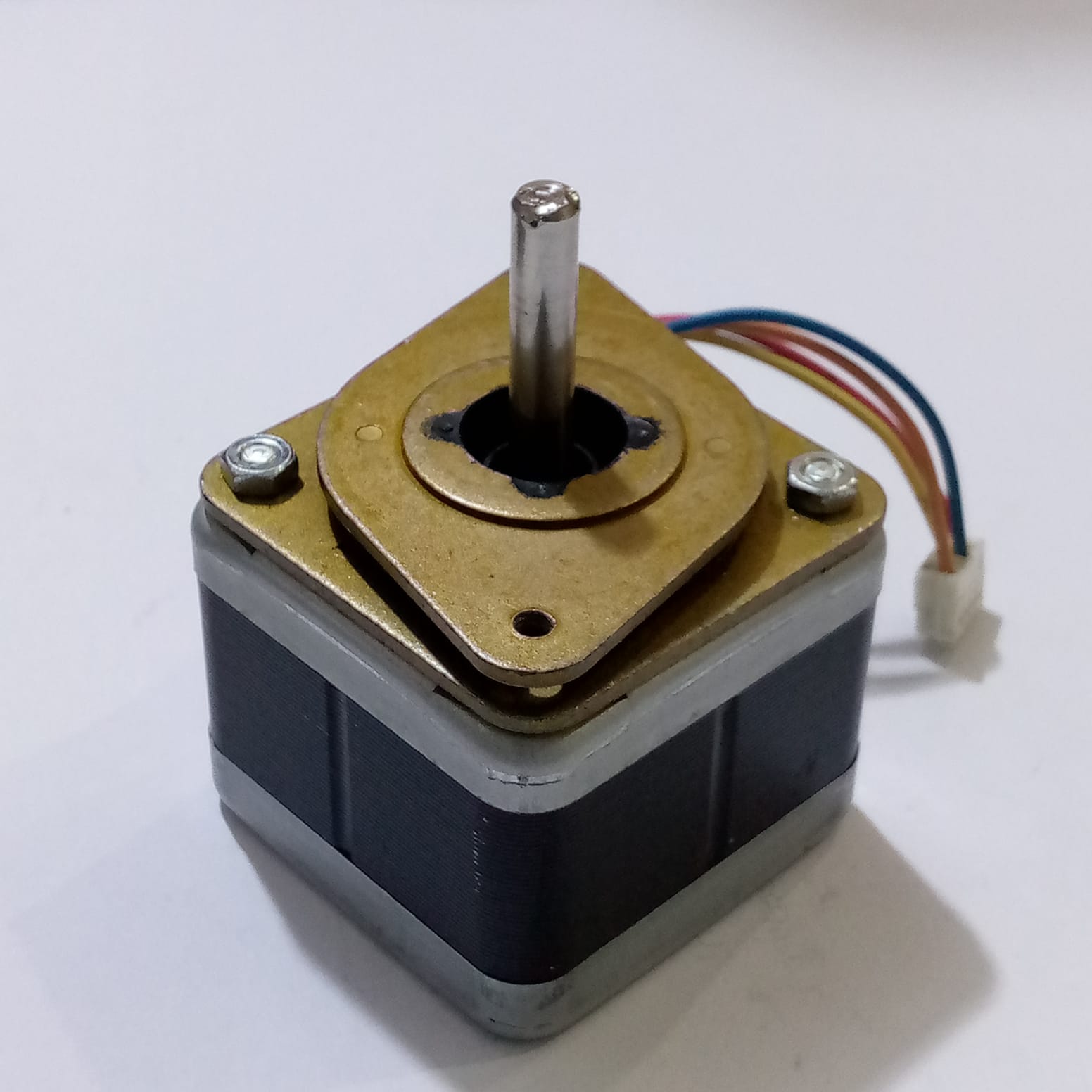 Minebea Bipolar 4 Wire Stepper Stepping Motor - a square-bodied motor with a central metal shaft, a brass-colored top plate, and a four-wire connector.