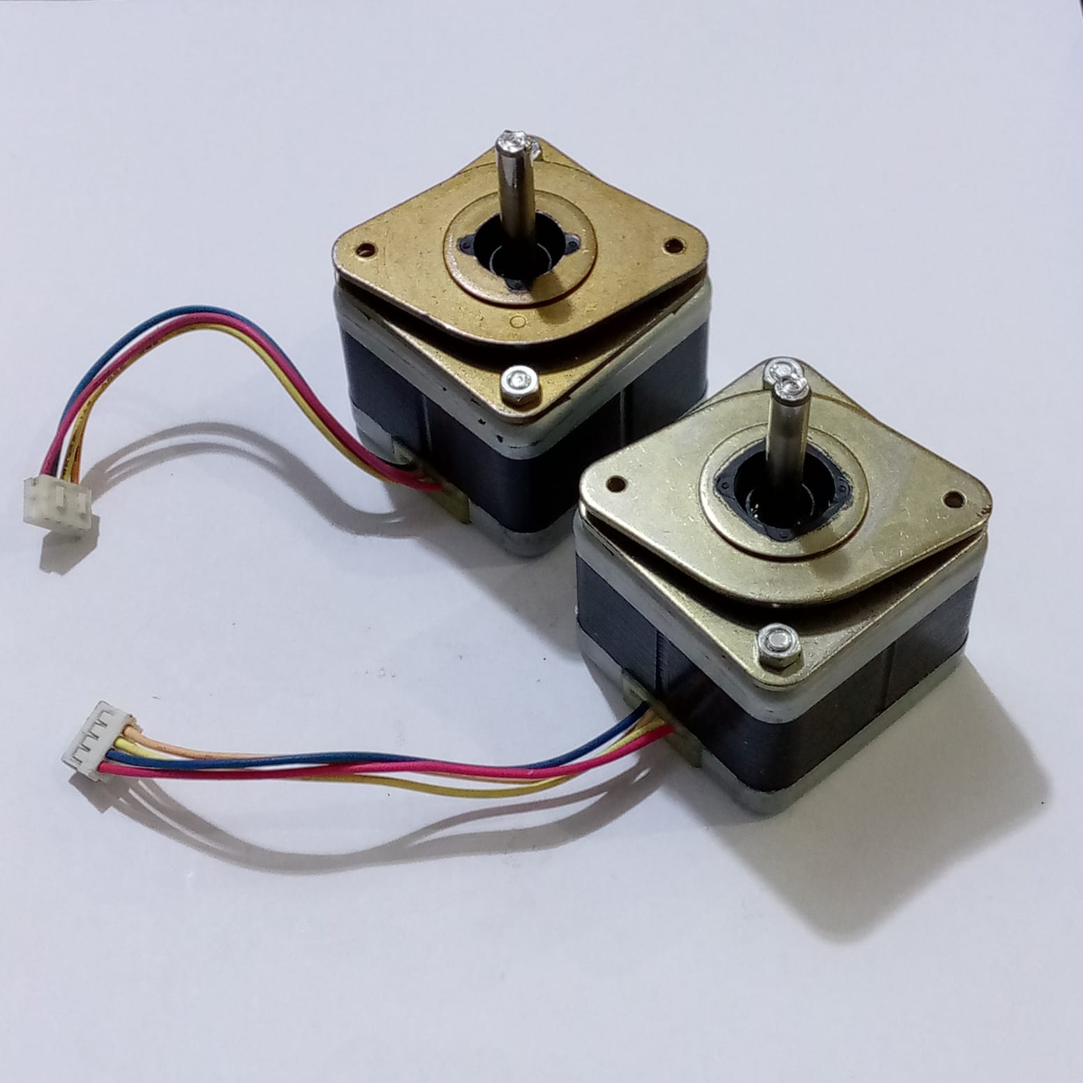 Minebea Bipolar 4 Wire Stepper Stepping Motor - two square-shaped metallic motors with central shafts and attached four-wire cables with connectors.